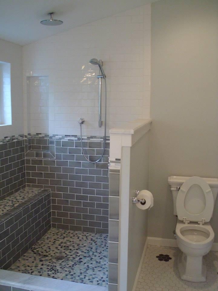 Completed Boston J's custom walk-in shower with gray subway tile walls, built-in bench and mosaic pebble shower floor