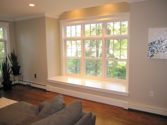 Custom oversized window seat with integrated bench and finished trim completed by Boston J's in a living room setting